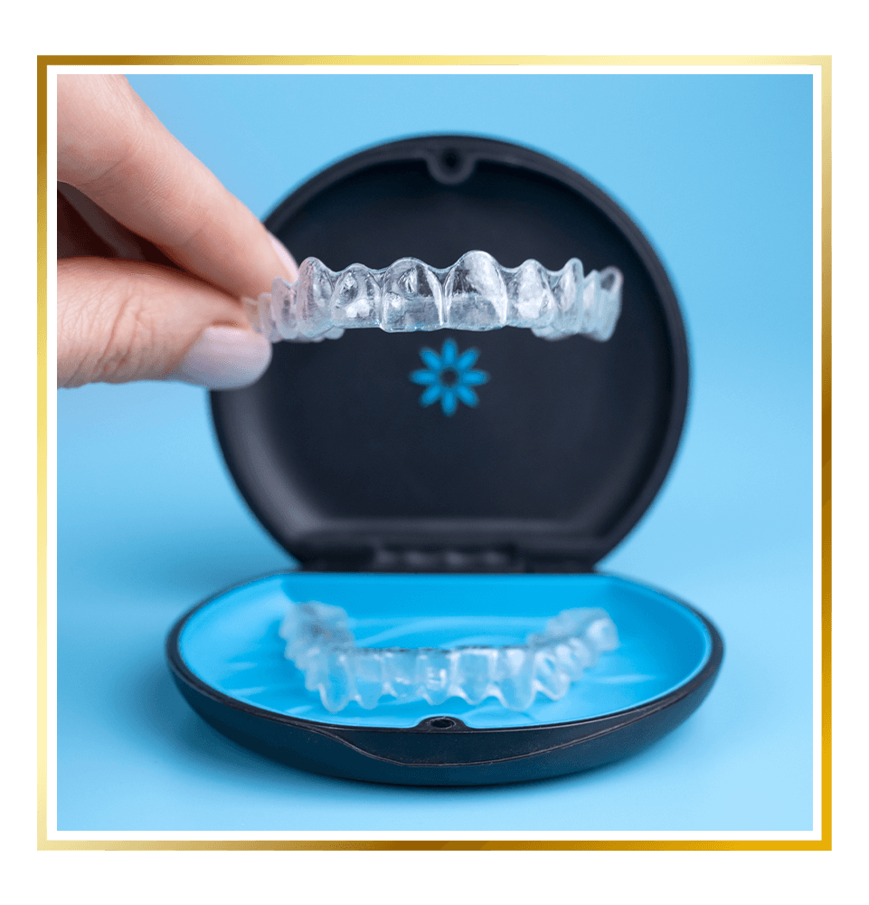 invisalign retainer being shown and held