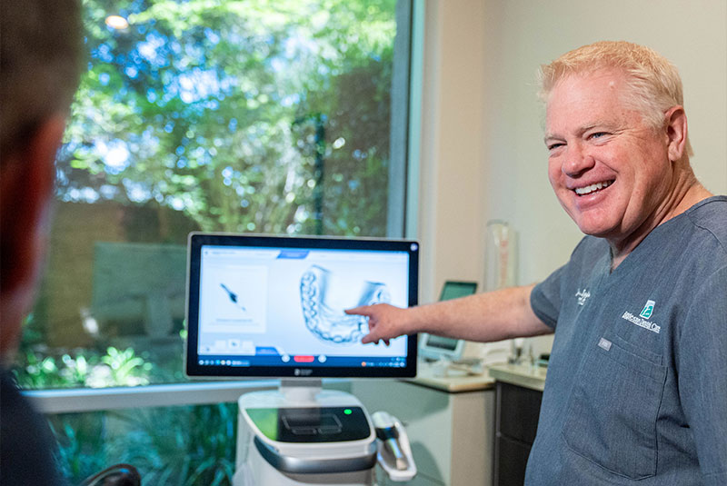dentist looking over a 3d scan of Patients teeth