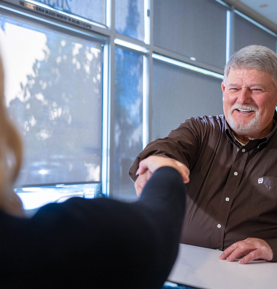 team member shaking Patient's hand