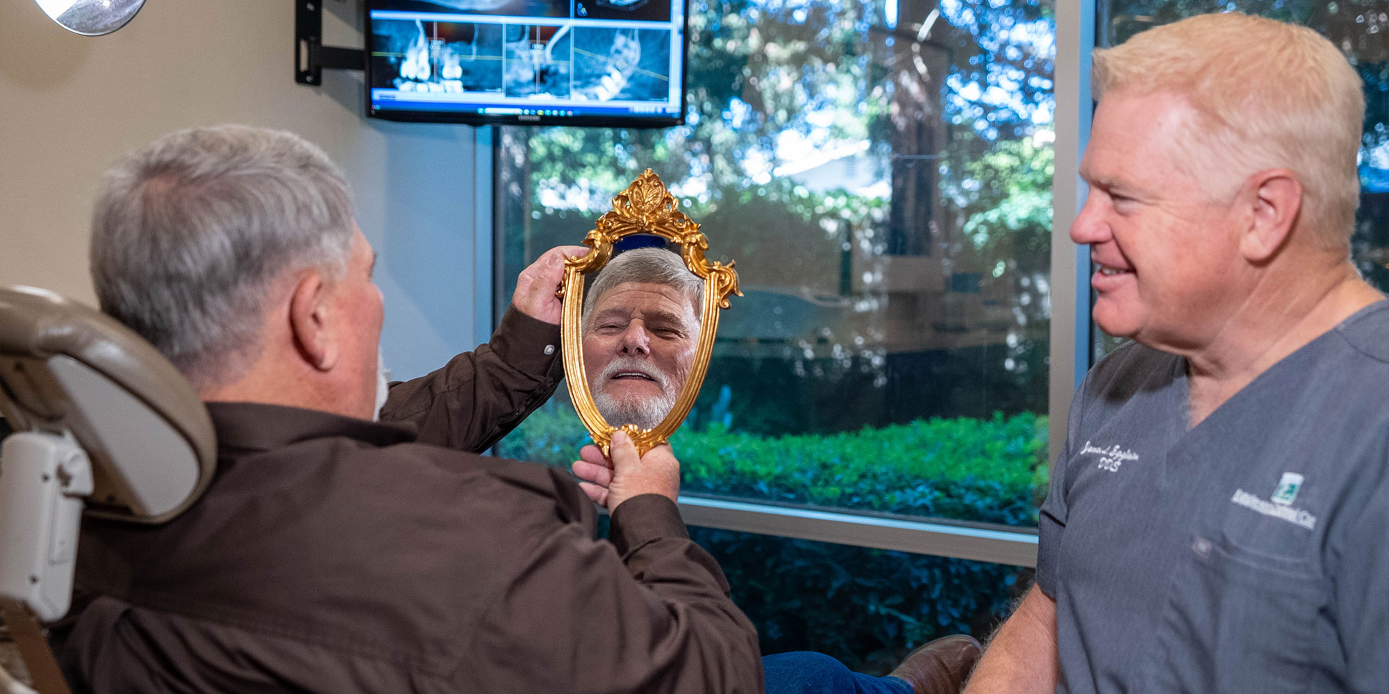 Dentist Looking into mirror with Paitent Smiling