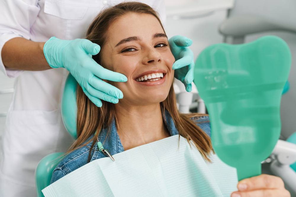 Dentist explaining dental veneer codes to a patient in a modern office.